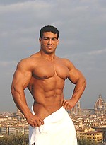 Tarek posing outdoors by Muscle Gallery