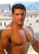 Tarek posing outdoors by Muscle Gallery