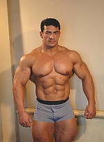 Tarek posing outdoors by Muscle Gallery