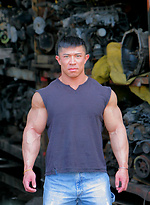Muscled asian man Daryl Gee posing by Muscle Gallery