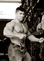 Muscled asian man Daryl Gee posing by Muscle Gallery