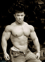 Muscled asian man Daryl Gee posing by Muscle Gallery