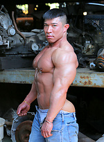 Muscled asian man Daryl Gee posing by Muscle Gallery