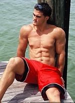Young jock Alain Lamas by the water by Mark Wolff