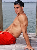 Young jock Alain Lamas by the water by Mark Wolff