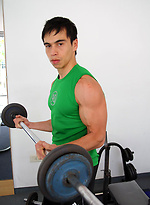 Young jock shows his sixpack in a gym by Bentley Race