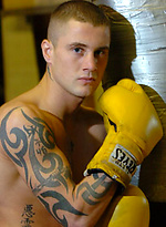 The heavily tattooed tough guy demurely stands on the scales covering his cock and balls by Ruggerbugger