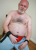 Fat & old David McNamara posing by Pantheon Bear