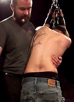 Sir has the boy right where he wants him, arms chained to the ceiling and awaiting punishment. by Iron Lockup